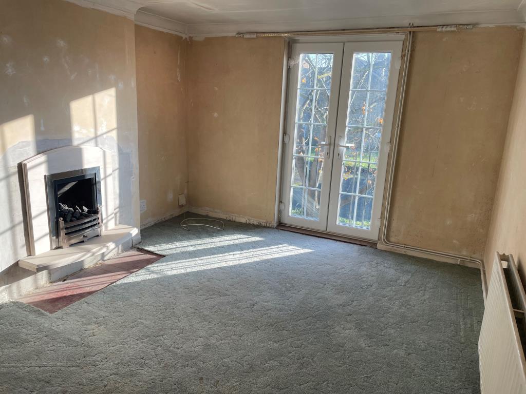 Lot: 69 - BALCONY FLAT FOR UPDATING IN DESIRABLE LOCATION - Living room with fireplace and access to balcony